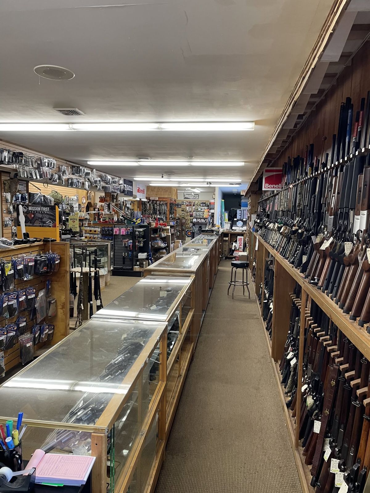 Main aisle with handgun cases and the long gun wall
